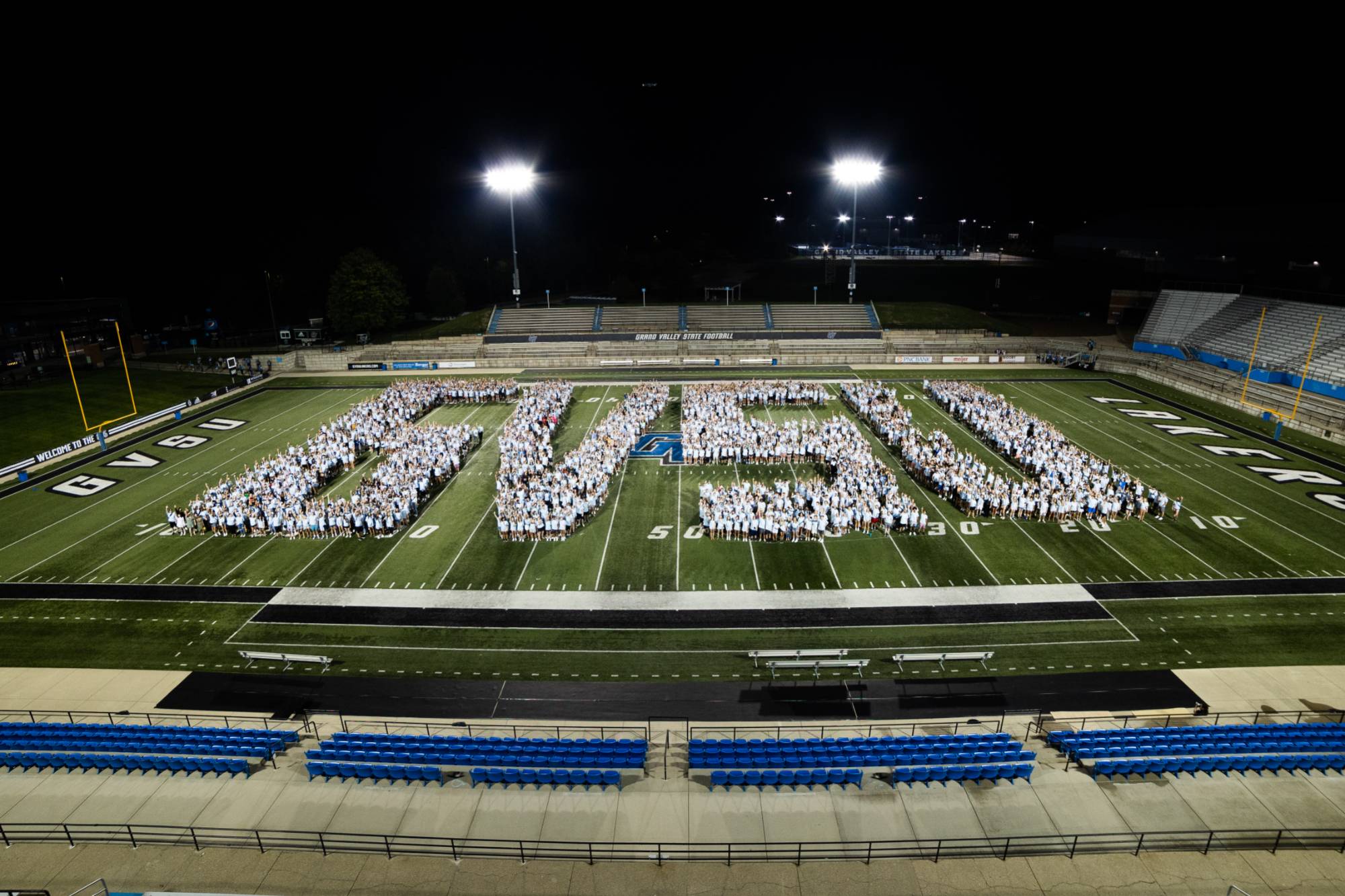 Class of 2026 class photo - students assembled on the football field to form the shape of the GVSU letters